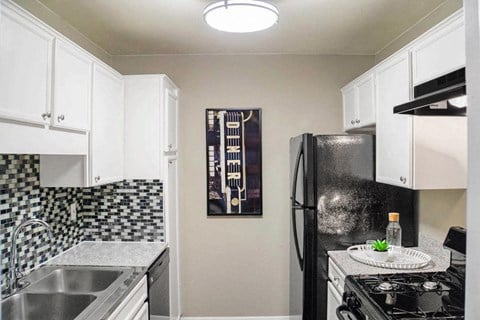 Fully Equipped Kitchen Includes Frost-Free Refrigerator, Electric Range, & Dishwasher at The Entro at Midtown, Dallas, TX